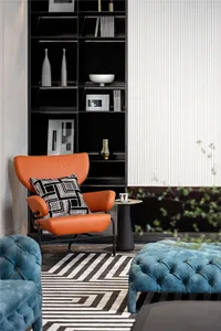 Contemporary lounge area with fabric upholstered ottoman and leather chair.