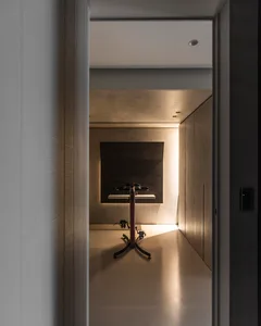 Modern home office designed with minimalist style, featuring a metal and concrete desk.
