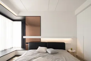 Modern bedroom with a black metallic panel headboard and light-colored bedding.