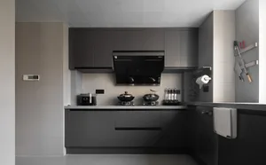 A modern black kitchen with concrete countertops and minimalist design elements.