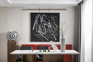 A contemporary dining room featuring a glass table with green apples and a white toy dinosaur on it, with a black and white a
