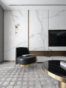 A modern living room with marble walls and a black armchair.