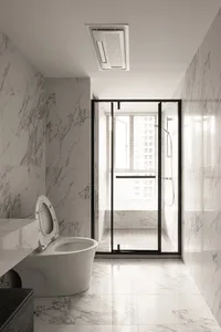 A modern bathroom featuring marble tiles, a glass shower enclosure, and a white toilet.