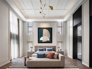 Modern bedroom featuring a bed with neutral-toned bedding, a bench, and abstract art.