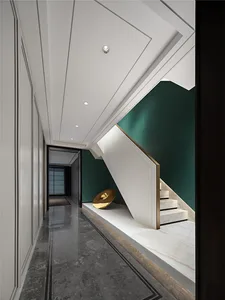 Modern, minimalist residential interior design featuring a marble staircase with a green accent wall and a minimalist art ins