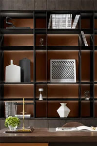 A modern minimalist bookshelf with black and white decorations and books.