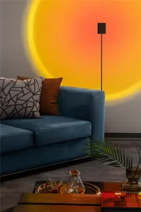 Blue sofa with geometric and brown pillows, illuminated by a sunburst shadow.