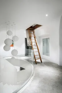 A minimalist-style staircase with a wooden ladder and modern lighting in a white room with concrete flooring.