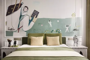 A minimalist bedroom featuring a green upholstered headboard and a playful, astronaut-themed mural on the wall.
