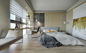 A modern minimalist bedroom with wood paneling, featuring a gray upholstered bed and a large abstract painting.