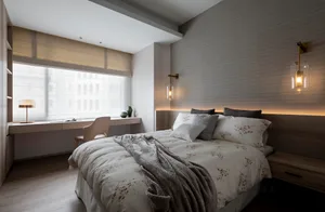 A modern bedroom featuring a wooden bed with floral bedding and sconce lighting.