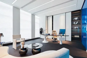 A modern office space featuring glass materials and contemporary design elements.
