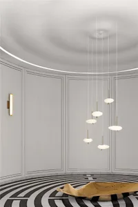 Modern, round room featuring geometric lighting fixtures and a unique floor pattern.
