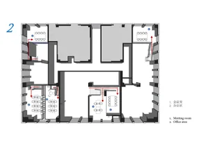 A 2D architectural drawing of an office space layout, showing meeting rooms, office areas, and staircases.