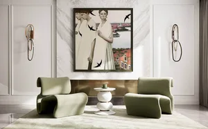 A modern living room featuring abstract art, green lounge chairs, and a geometric side table.