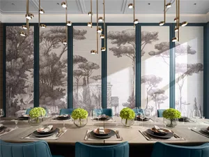 A modern dining room with a long wooden table, blue fabric chairs, and glass pendant lights.