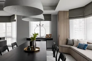 Modern dining room featuring wood furniture, comfortable seating, and glass accents.