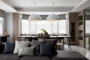 A modern neutral-toned living dining room with a large window, comfortable seating, and a sleek dining table.