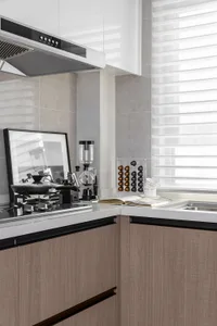 Modern minimalist kitchen featuring granite countertops and wooden texture cabinets.