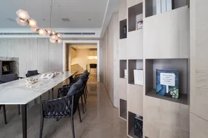 Modern dining room featuring marble countertops and concrete walls