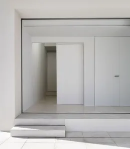 A minimalist modern entryway with a concrete floor and walls.