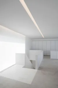 Modern, minimalist interior design with concrete walls and floor.