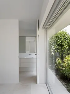 Modern minimalist bathroom with concrete walls and a clean, uncluttered design.