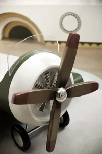 An industrial-style toy airplane with a metal propeller.