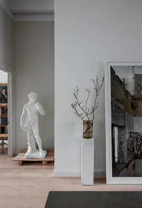 Modern Art Deco interior design featuring a minimalist white marble sculpture in a contemporary setting.