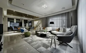 A contemporary living room featuring a spacious marble floor, a comfortable sofa, and modern furniture.
