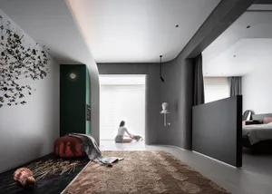 A modern minimalist residential interior featuring concrete, wood, and glass materials.