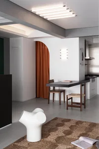 Modern residential interior featuring neutral tones, wooden furniture, and marble accents.