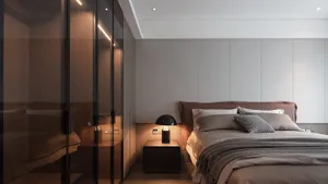 Minimalist bedroom design featuring a bed with textured fabric bedding, a sleek nightstand lamp, and minimalist decor.