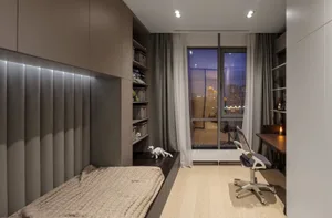 Modern bedroom with wooden flooring, glass window, and fabric furniture