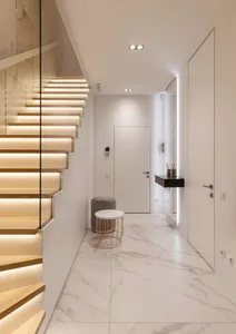 Modern entryway featuring marble flooring, minimalist design, and sleek, elegant lighting.