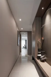 A modern, minimalist hallway with a long, narrow floor plan and a wooden wall