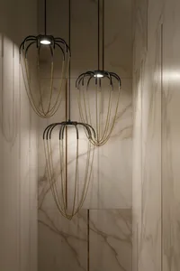 Modern lighting fixtures with metal chains hanging from the ceiling in a modern interior setting.