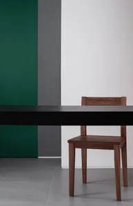 A minimalist modern interior with a wooden table and chair.