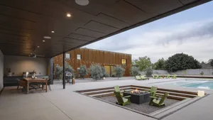 Modern residential exterior featuring a clay tile roof and large glass windows.