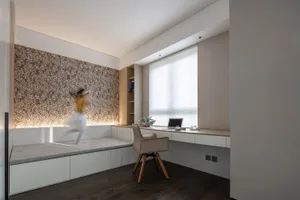 A modern, minimalist small space interior design with a wooden chair and built-in shelves.