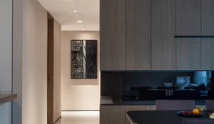 Modern kitchen featuring wooden cabinets and black countertop.