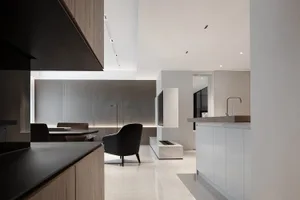 A modern kitchen featuring marble countertops and a minimalist design.