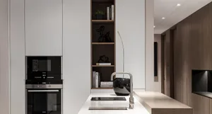 A modern kitchen interior with white marble countertops.
