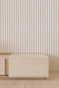 The image features a minimalist travertine sofa, showcasing a sleek, modern design with natural stone elements.