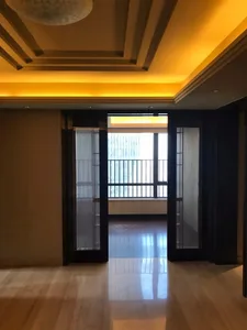 Modern glass balcony entranceway with a warm lighting fixture.