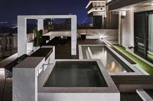 An outdoor residential patio featuring concrete and glass elements.