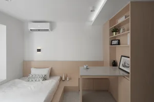 Modern minimalist bedroom featuring a wooden shelf and desk, white bedding, and a clean, uncluttered design.