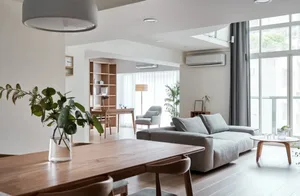 A modern minimalistic living room featuring sleek wooden furniture, glass elements, and upholstered fabric seating.