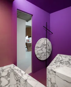 Modern interior space with purple walls and marble accents.