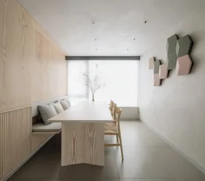 A modern interior design space featuring wooden furniture and a minimalist aesthetic.